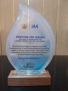 Prof. Amin Alhassan proudly displaying the plaque received for Best Head of Covered Entity Award at the 2023 Annual Internal Audit Conference.